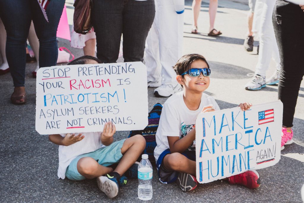 Children holding signs in protest of the Trump administration’s immigration policy