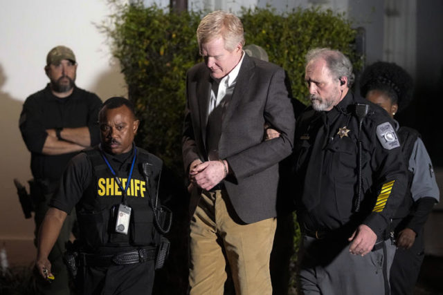 Alex Murdaugh is led outside the Colleton County Courthouse by sheriff's deputies after being convicted of two counts of murder Thursday in Walterboro, S.C., in the June 7, 2021, shooting deaths of his wife and son. (Chris Carlson/AP)